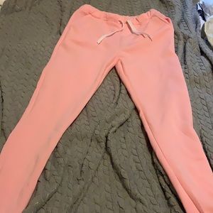 Never worn, jogging pants color pink adjustable